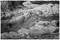 White crossbedded sandstone layer capping twirls of red sandstone. Vermilion Cliffs National Monument, Arizona, USA ( black and white)