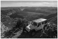 Jeep and visitors on rim edge of Grand Canyon. Parashant National Monument, Arizona, USA ( black and white)