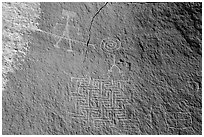 Petroglyph depicting person wearing earrings with ladder-like insect and maze. Vermilion Cliffs National Monument, Arizona, USA ( black and white)