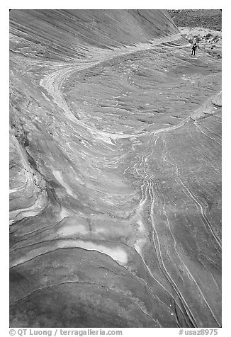 Hiker on rock on the way to the Wave. Coyote Buttes, Vermilion cliffs National Monument, Arizona, USA