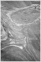 Hiker on rock on the way to the Wave. Coyote Buttes, Vermilion cliffs National Monument, Arizona, USA (black and white)