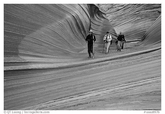 Hikers walk out of the Wave. Coyote Buttes, Vermilion cliffs National Monument, Arizona, USA