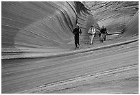 Hikers walk out of the Wave. Coyote Buttes, Vermilion cliffs National Monument, Arizona, USA ( black and white)