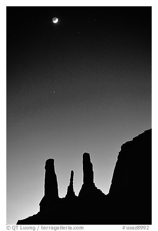 Three sisters and moon, dusk. Monument Valley Tribal Park, Navajo Nation, Arizona and Utah, USA (black and white)