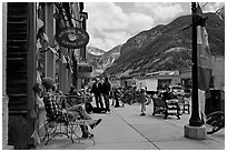 Men sitting on main street sidewalk. Telluride, Colorado, USA (black and white)