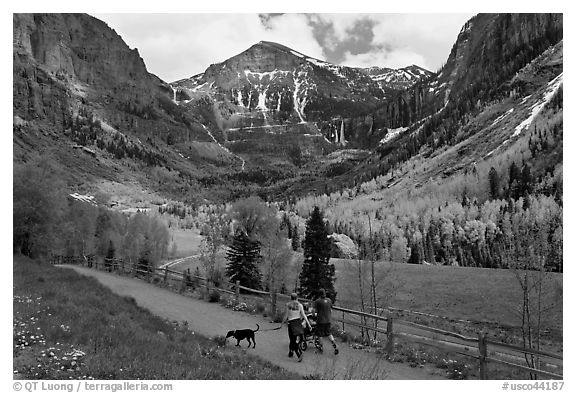 Family hiking on trail towards Bridalveil Falls in the spring. Telluride, Colorado, USA