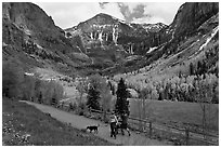 Family hiking on trail towards Bridalveil Falls in the spring. Telluride, Colorado, USA (black and white)