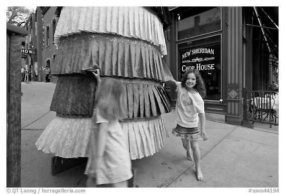 Girls spin tibetan prayer wheel. Telluride, Colorado, USA