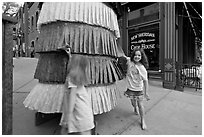 Girls spin tibetan prayer wheel. Telluride, Colorado, USA ( black and white)