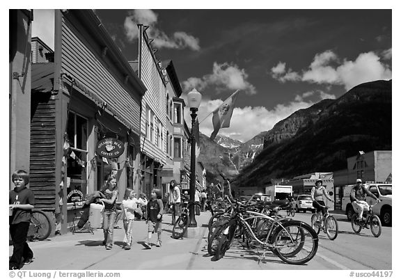 Children walking on main street past mountain bikes. Telluride, Colorado, USA (black and white)