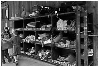 Family tries out clothes from sharing box. Telluride, Colorado, USA ( black and white)