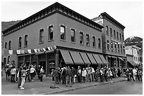 Festival attendees line up on sidewalk. Telluride, Colorado, USA (black and white)