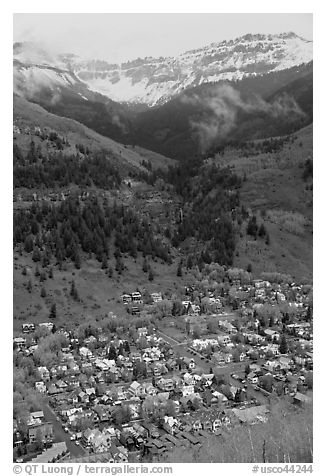 Town, waterfall, and snowy mountains in spring. Telluride, Colorado, USA (black and white)