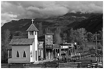 Western-style buildings and horses, Ridgeway. Colorado, USA (black and white)