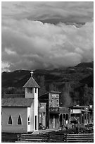 Horses grazing in front of historic-looking buildings, Ridgeway. Colorado, USA ( black and white)