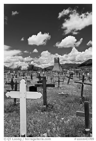 Wooden crosses and old adobe church. Taos, New Mexico, USA (black and white)