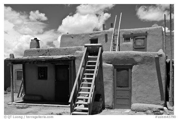 Multi-story pueblo houses with ladders. Taos, New Mexico, USA