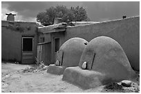 Traditional pueblo ovens. Taos, New Mexico, USA (black and white)