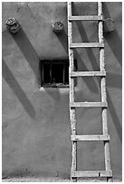 Ladder, Vigas, and blue window. Taos, New Mexico, USA (black and white)