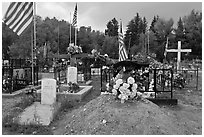 Headstones, tombs and american flags. Taos, New Mexico, USA (black and white)