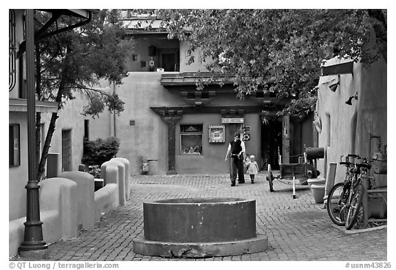 Pedestrian alley with woman and child. Taos, New Mexico, USA (black and white)