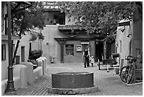 Pedestrian alley with woman and child. Taos, New Mexico, USA (black and white)