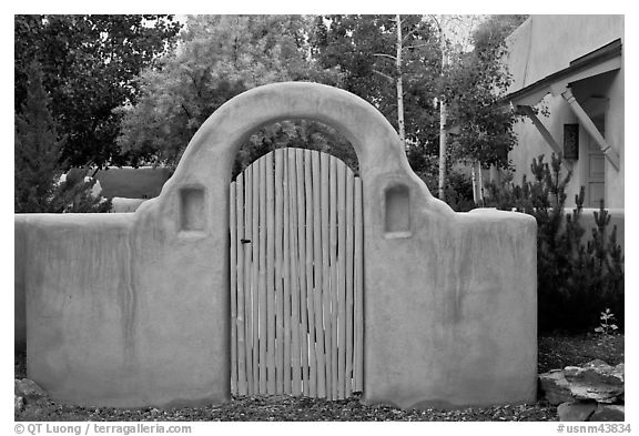 Blue door and adobe yard wall. Taos, New Mexico, USA