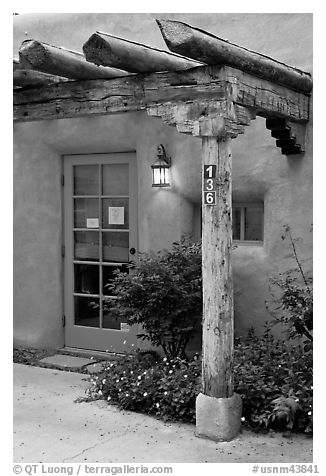 Blue door and window at house entrance. Taos, New Mexico, USA (black and white)