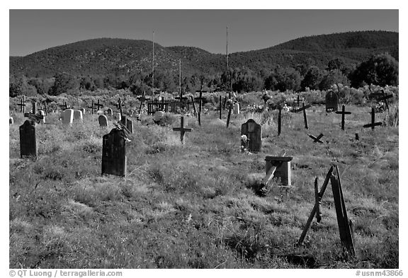 Headstones in grassy area, cemetery, Picuris Pueblo. New Mexico, USA (black and white)