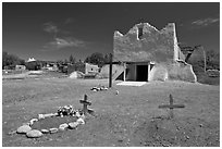 Graves and Picuris Church, Picuris Pueblo. New Mexico, USA (black and white)