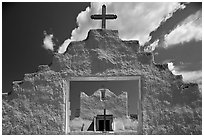 Adobe church framed by entrance in earthen wall, Picuris Pueblo. New Mexico, USA (black and white)