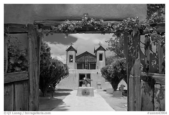 Church framed by doors with roses, Sanctuario de Chimayo. New Mexico, USA (black and white)