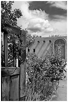 Gardens and adobe wall, Sanctuario de Chimayo. New Mexico, USA (black and white)