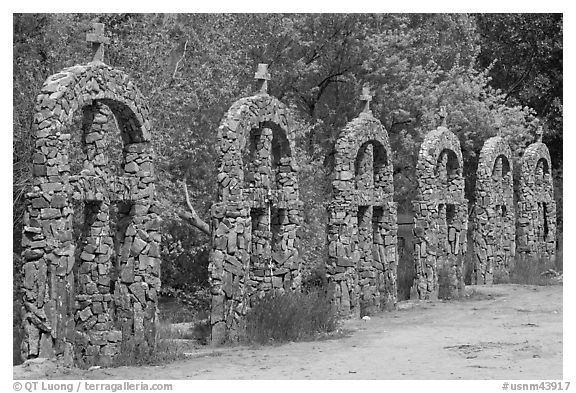 Brick and stone crosses by the river, Sanctuario de Chimayo. New Mexico, USA