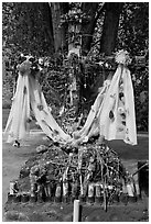 Cross festoned with popular devotion objects, Sanctuario de Chimayo. New Mexico, USA (black and white)