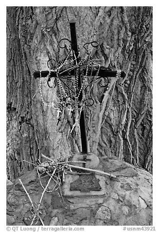 Metal cross festoned with rosaries, and crosses made of twigs, Sanctuario de Chimayo. New Mexico, USA