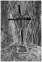 Metal cross festoned with rosaries, and crosses made of twigs, Sanctuario de Chimayo. New Mexico, USA (black and white)
