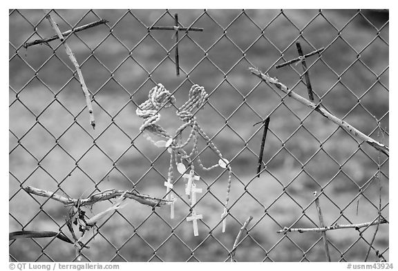 Chain-link fence with rosaries and improvised crosses, Sanctuario de Chimayo. New Mexico, USA