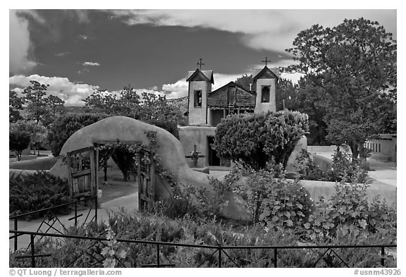 Gardens and walled courtyard, Sanctuario de Chimayo. New Mexico, USA (black and white)