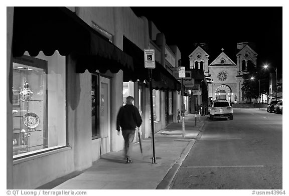 Man walking gallery and St Francis by night. Santa Fe, New Mexico, USA (black and white)