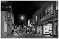 Street with galleries, people walking, and cathedral by night. Santa Fe, New Mexico, USA (black and white)