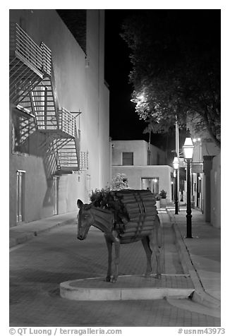 Street with sculpture by night. Santa Fe, New Mexico, USA