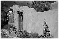 Adobe wall and weathered wooden door and window. Santa Fe, New Mexico, USA ( black and white)