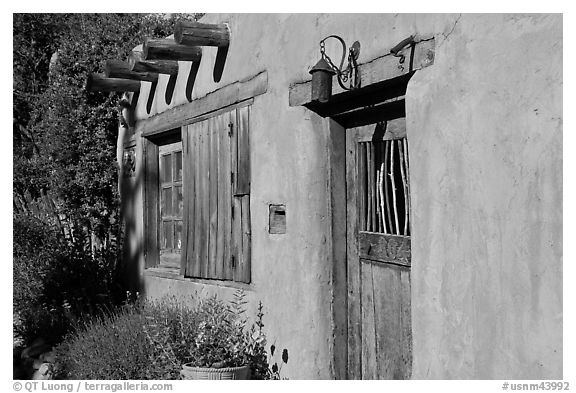 Door, window, and vigas (wooden beams). Santa Fe, New Mexico, USA (black and white)