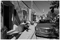 Couple reading art magazine in front of gallery. Santa Fe, New Mexico, USA ( black and white)