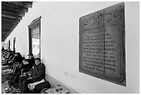 Sign explaining history of Palace of the Governors. Santa Fe, New Mexico, USA (black and white)