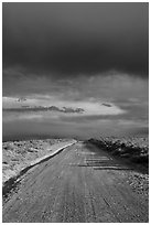 Dirt road under storm clouds. New Mexico, USA ( black and white)