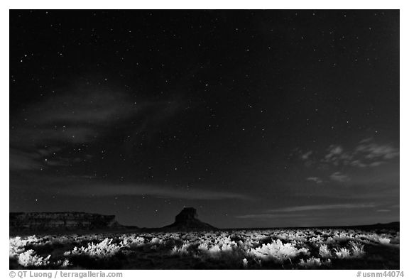 Night landscape with lighted canyon floor. Chaco Culture National Historic Park, New Mexico, USA (black and white)