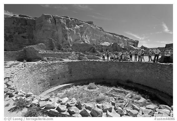 Tourists during a tour of Pueblo Bonito. Chaco Culture National Historic Park, New Mexico, USA (black and white)