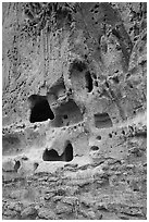 Natureal cavities and architectural carvings in tuff wall. Bandelier National Monument, New Mexico, USA ( black and white)